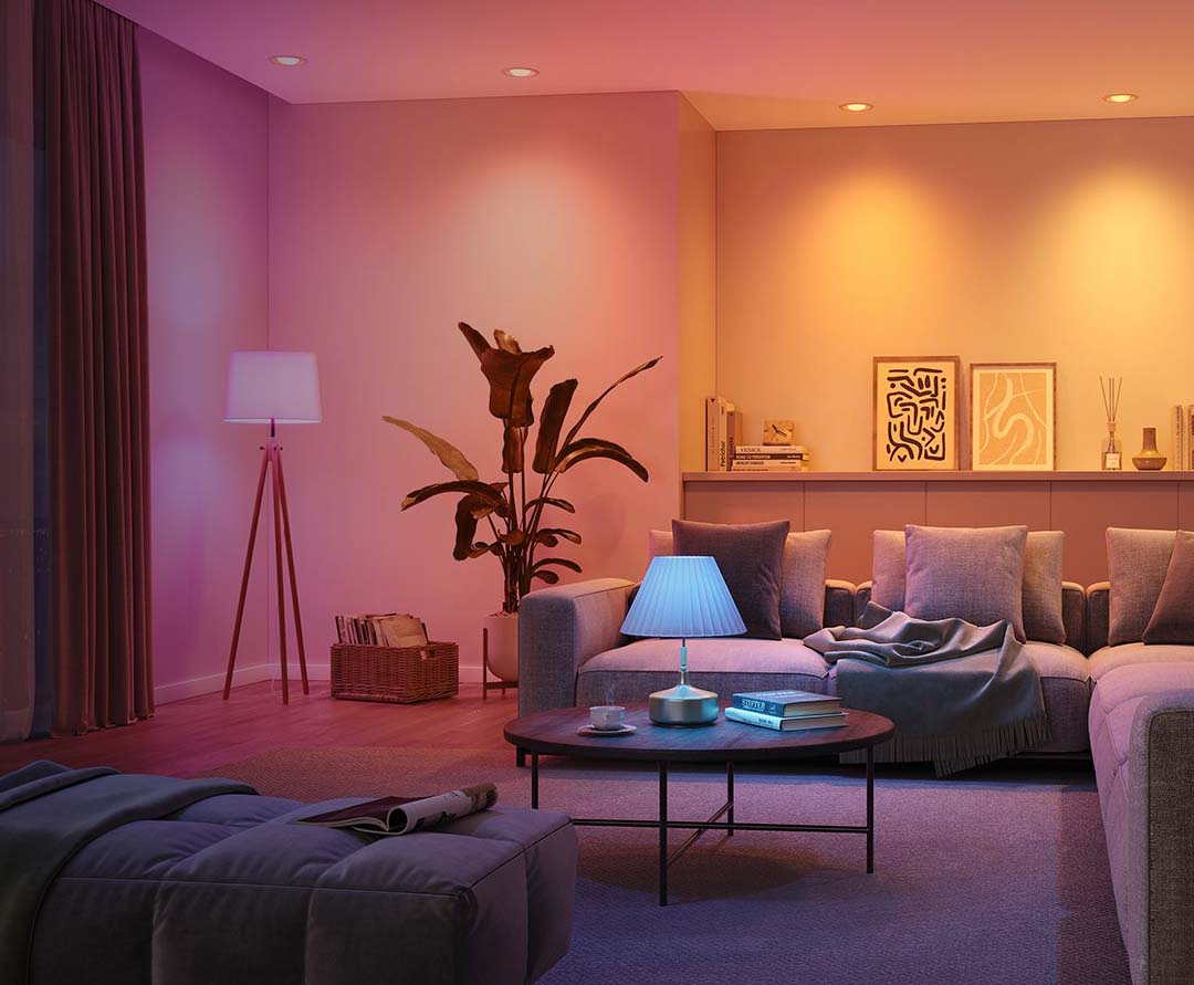 Modern living room with pink and yellow lighting, furniture, and decor.